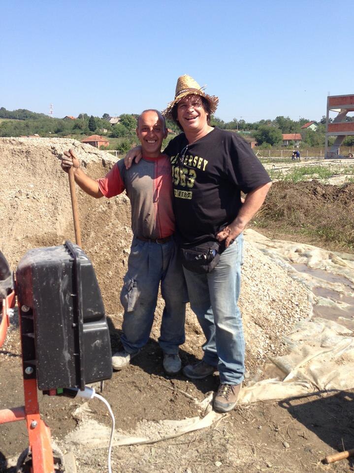 Canberra Green Shed co-owner Goran 'Tiny' Srejic with an amusement park worker in Serbia.