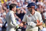 England's Alastair Cook (R), is congratulated by Australia's Tim Paine at stumps on day two at MCG.