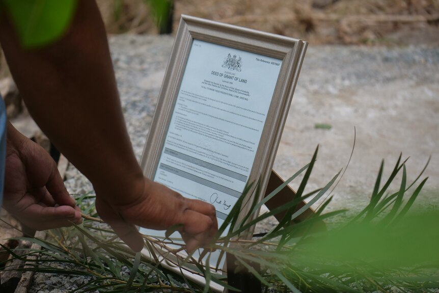 A document nestled in rocks and grass.