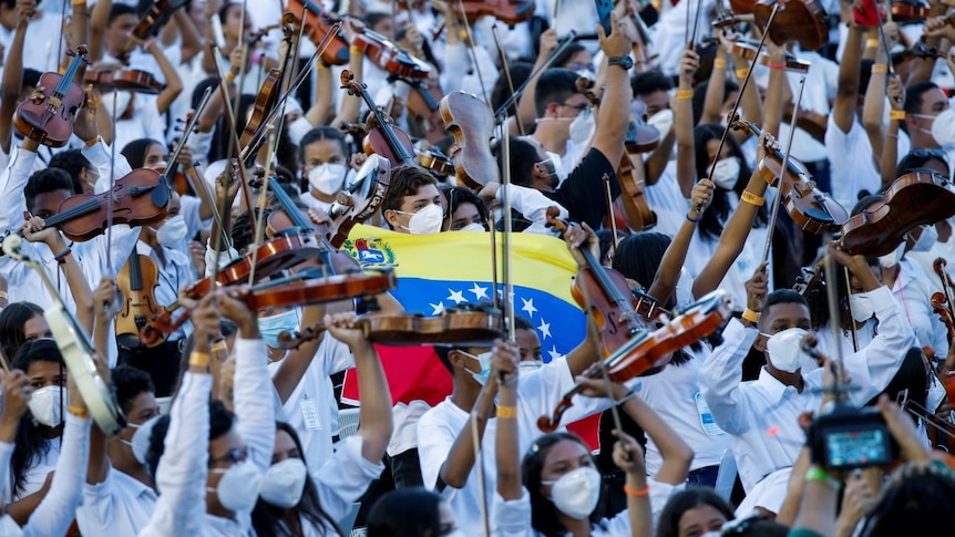 Thousands of Musicians of Venezuela's National System of Youth Orchestras and Choirs take part in a concert .