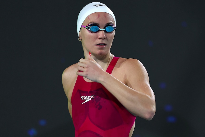 Ariarne Titmus looks towards the pool while wearing goggles at the Australian Olympic swimming trials.