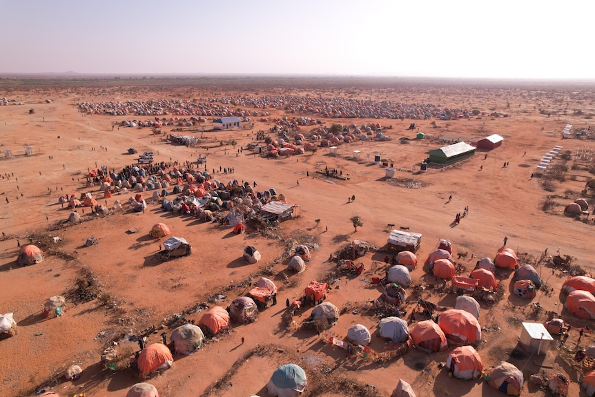 Tents in a dry desert.