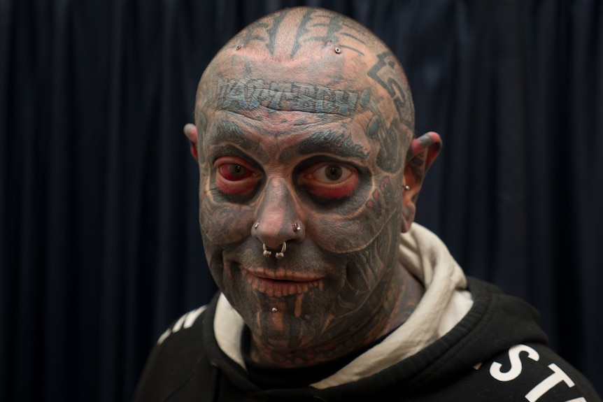 Tattboy Holden shows his extensive facial tattoos.