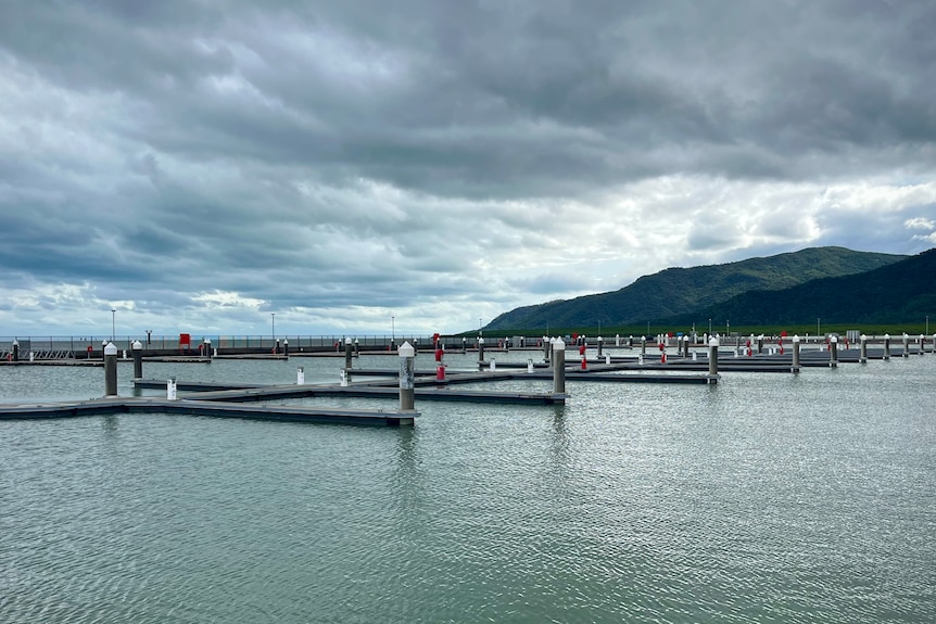 a wide image of an empty marina with large dark clouds overhead