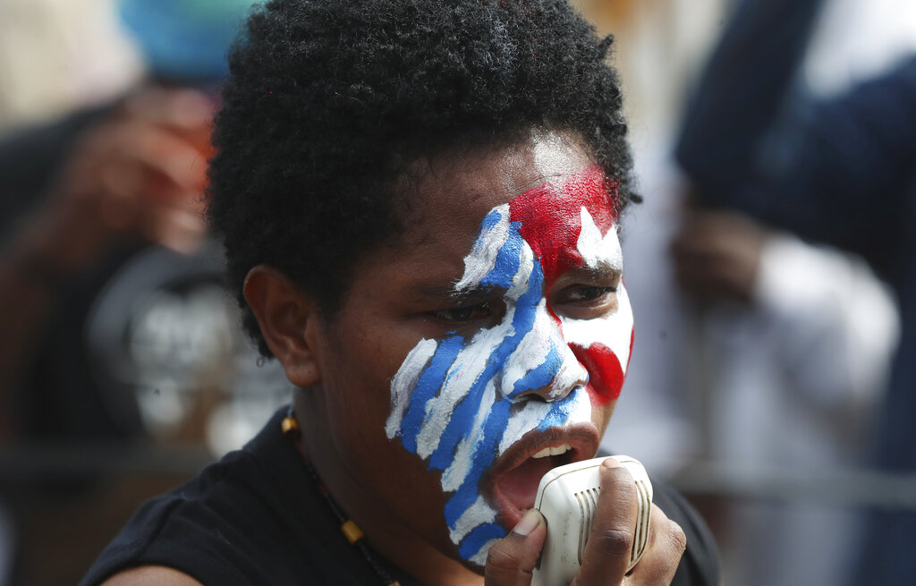 A supporter of the independence of the West Papua with face painted with the colors, white, red and blue.