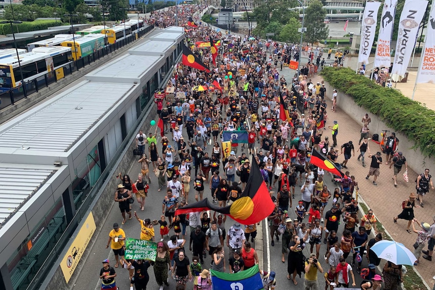 An overhead photo showing a crowd with Aboriginal flags.