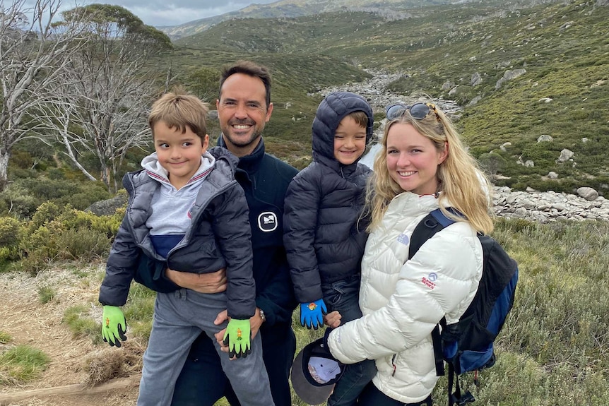 Millie and Massimo di Maio with their children with green mountains in the background.