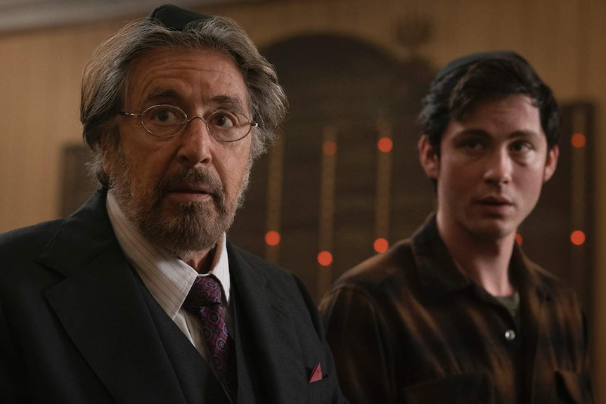 A still of Al Pacino and Logan Lerman in Hunters, Pacino is in a suit, Lerman is in a flannelette shirt.