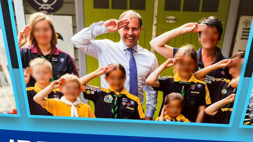 josh frydenberg doing a scouts salute in the middle of scouts on a corflute