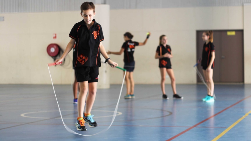 a young boy skipping rope