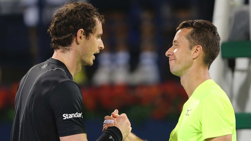 Britain's Andy Murray (L) and Philipp Kohlscreiber shake hands after Dubai tennis quarter-final.
