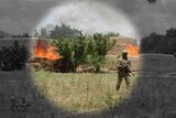 A soldier walks away from a fire in regional Afghanistan