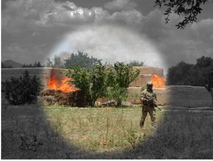 A soldier walks away from a fire in regional Afghanistan