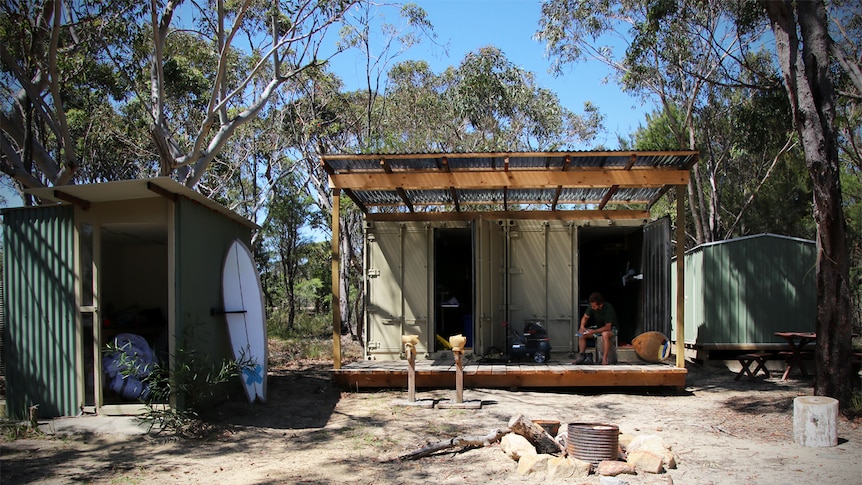 Dave Porter's surfing retreat with two shipping containers, outdoor kitchen and camp fire in foreground.