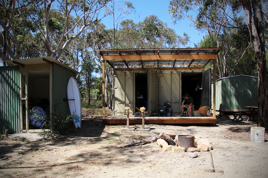 Dave Porter's surfing retreat with two shipping containers, outdoor kitchen and camp fire in foreground.