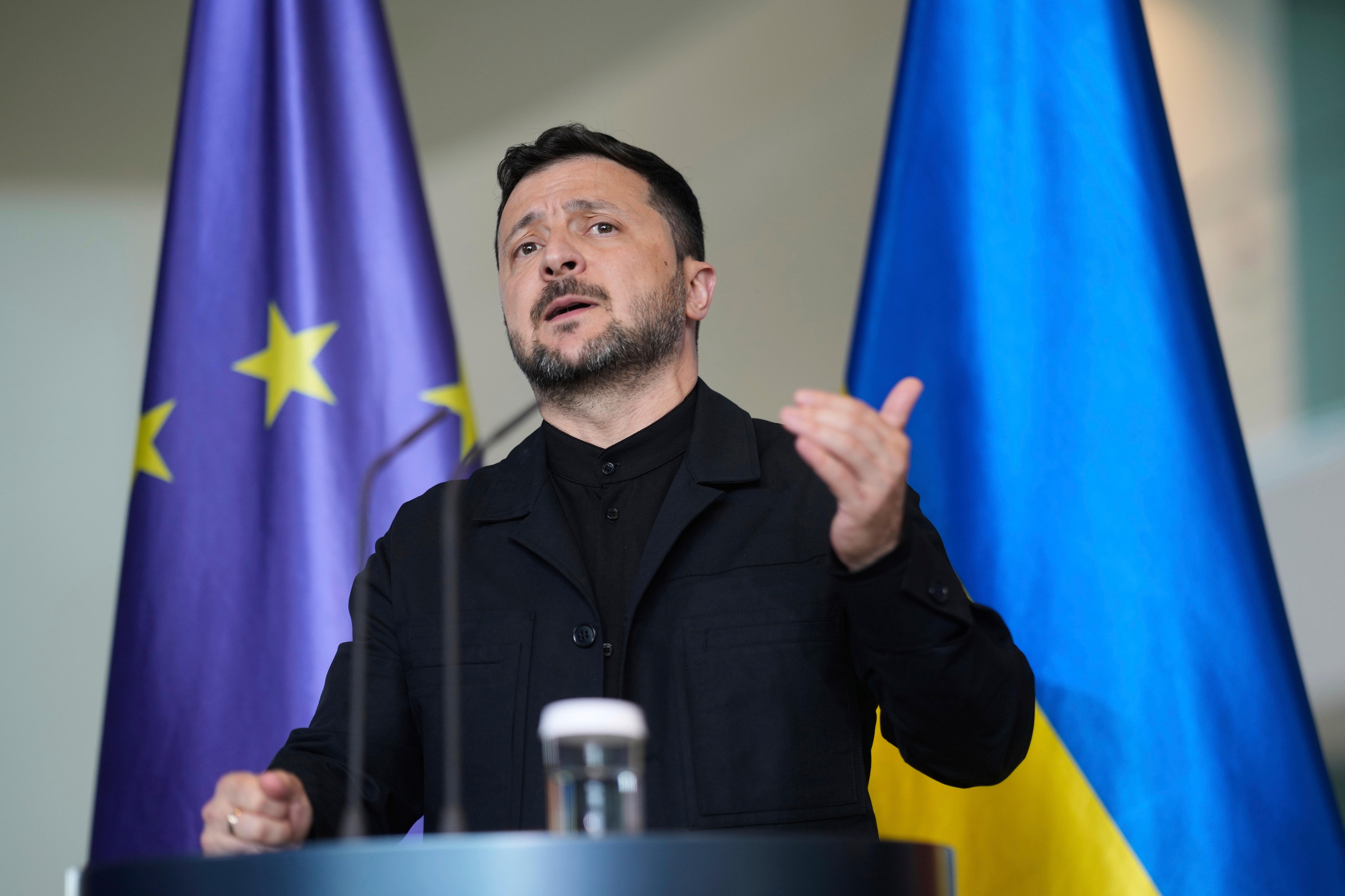 Volodymyr Zelenskyy gestures during a news conference