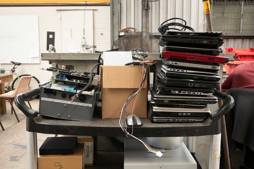 A pile of laptops and other electronic waste.