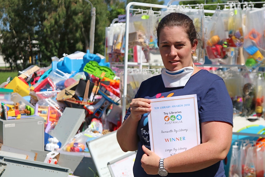 Townsville toy library vice president Erin Kiernan holds an award for Australia's best large toy library