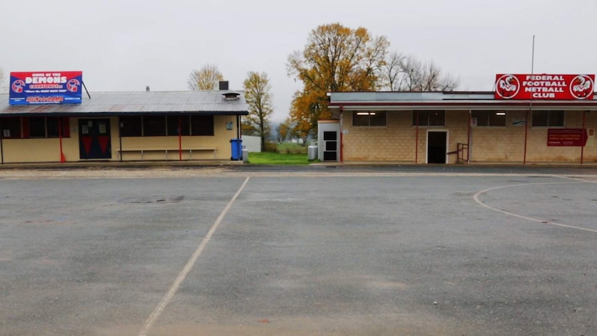 Two Aussie Rules football clubrooms are separated by just a few metres.
