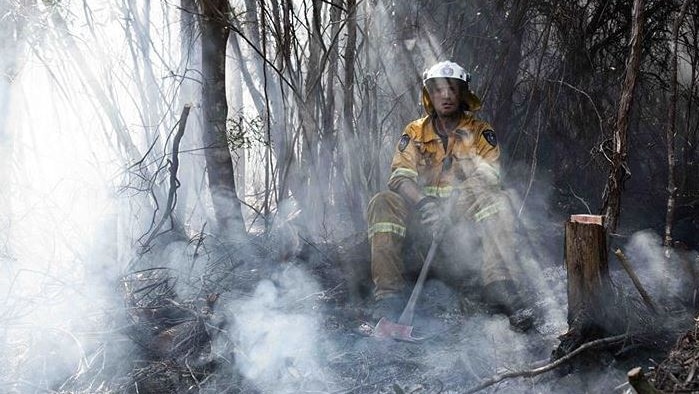 Firefighter takes a break during Tasmanian bushfires.