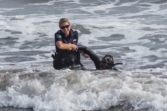 A passing police officer rescued a man from the sea