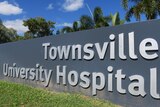 Large lettering on a boundary wall saying "Townsville University Hospital".