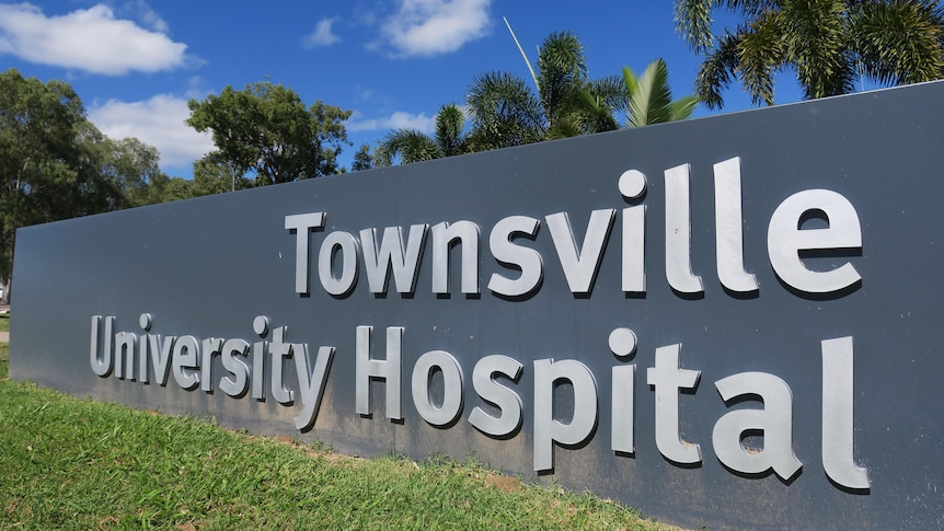 Large lettering on a boundary wall saying "Townsville University Hospital".