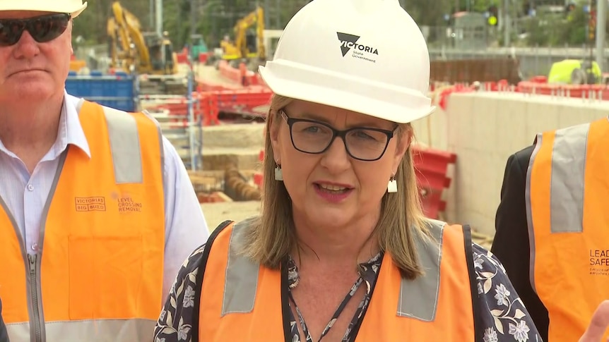Victorian Premier Jacinta Allan in a high vis jacket and hard hat addressing media.
