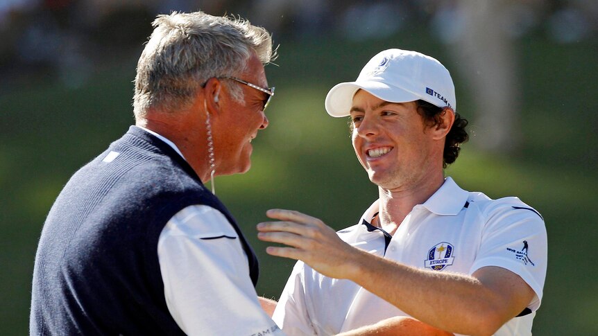 Team Europe golfer Rory McElroy, Northern Ireland embraces vice captain Darren Clarke after winning his Ryder Cup match