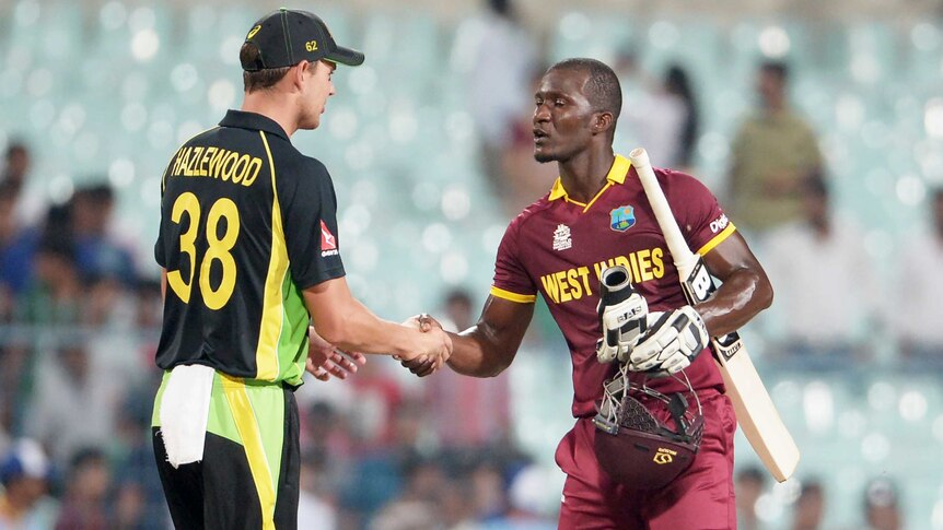 Australia's Josh Hazlewood (L) and West Indies' Darren Sammy shake hands after World T20 warm-up.