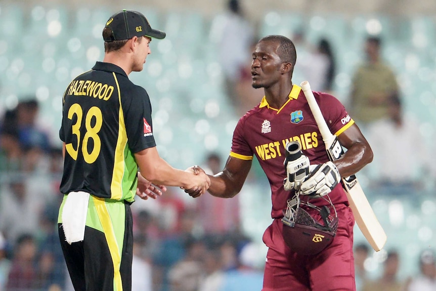 Australia's Josh Hazlewood and West Indies captain Darren Sammy shake hands after T20 practice match