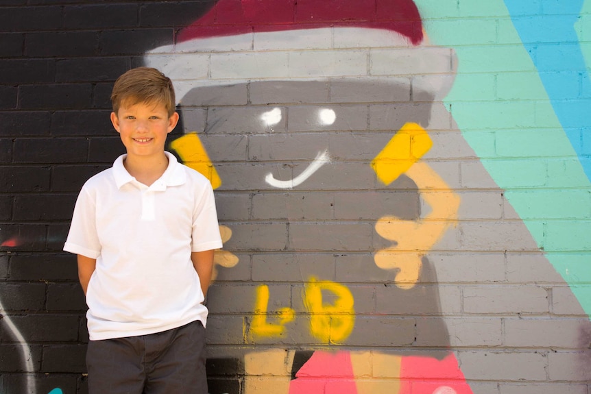 Nine-year-old Luke Beckett with his favourite character, a spray can with arms and legs.