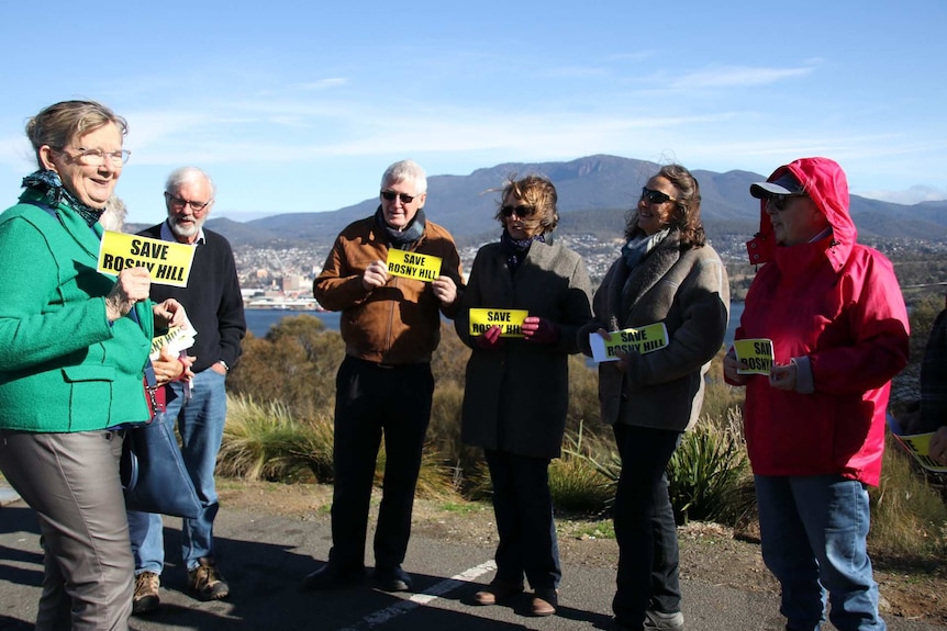 Members of the Save Rosny Hill Friends Network stand at the site
