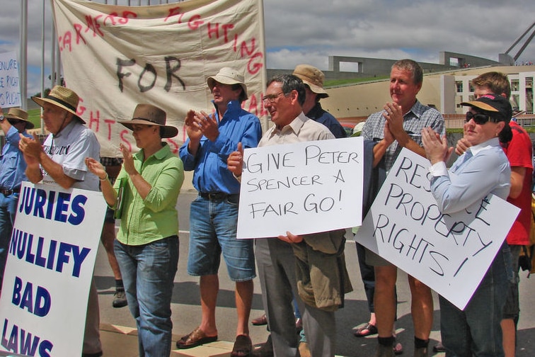 People rally outside Parliament House in protest against land clearing laws