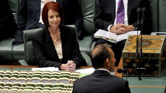 Prime Minister Julia Gillard listens to Opposition Leader Tony Abbott during Question Time (AAP: Alan Porritt)