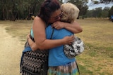 Yarloop residents Ada Farmer (left) and Kath King hug each other.