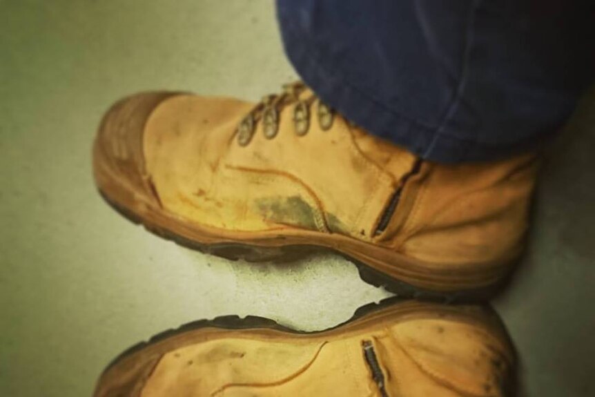 Looking down on a pair of work boots