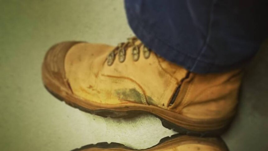 Looking down on a pair of work boots