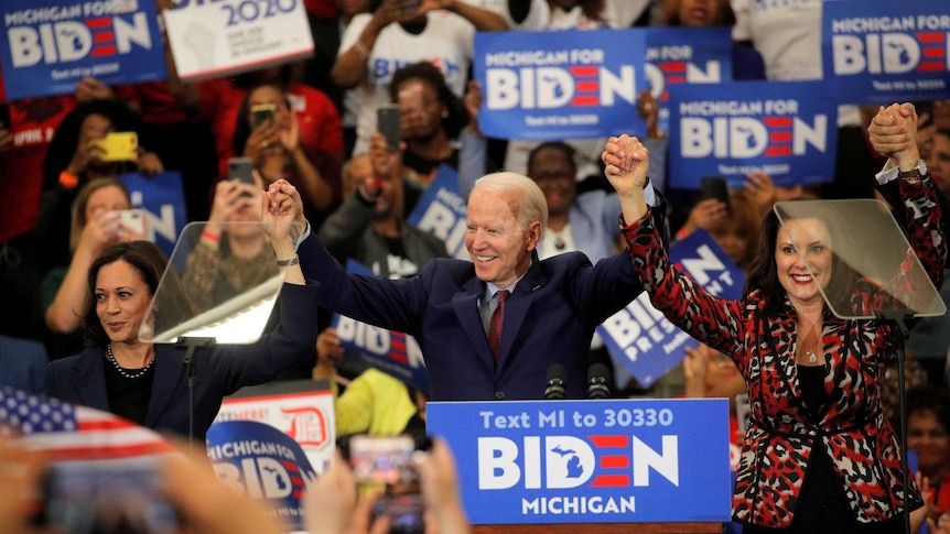 Joe Biden holds cheers with Kamala Harris and Gretchen Whitmer