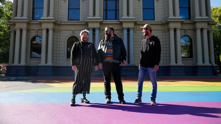 A group of people standing in front of a building.