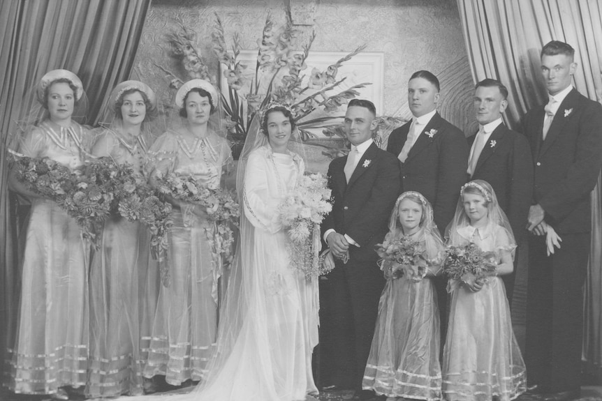 A black and white photograph of a wedding party.