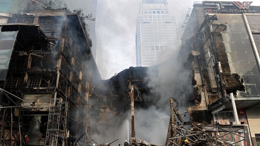 Thai firemen try to douse the flames at Thailand's biggest shopping mall