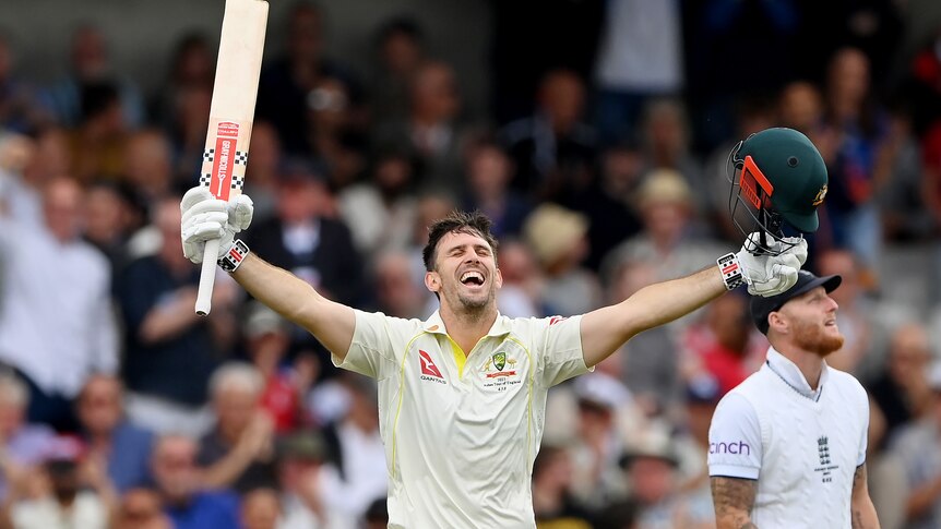 Mitch Marsh closes his eyes as he holds his bat and helmet up