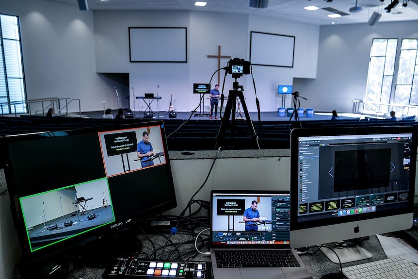 TV screens and a camera in a church auditorium