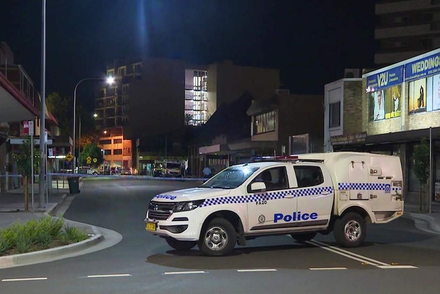 A police car blocks a street.