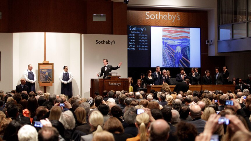 A crowded Sotheby's auction room with The Scream painting displayed on a screen. 