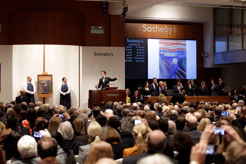 A crowded auction room with The Scream painting displayed on a screen. 
