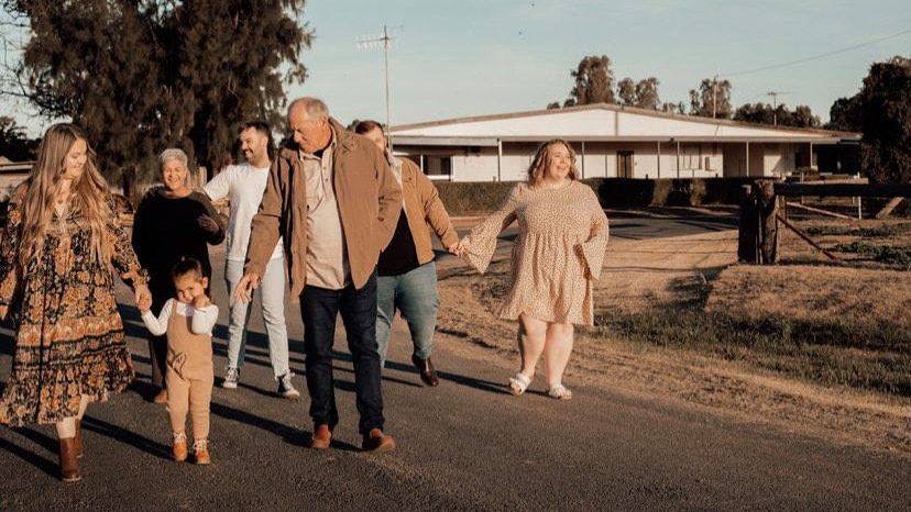 Members of Rowdie Walden's family walk down the street together in Narromine, NSW.