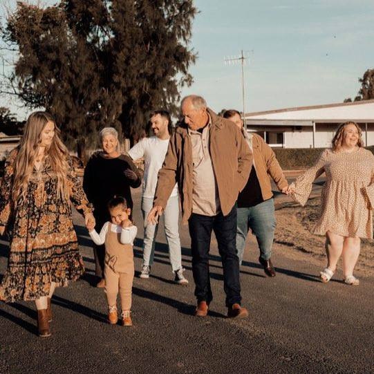 Members of Rowdie Walden's family walk down the street together in Narromine, NSW.
