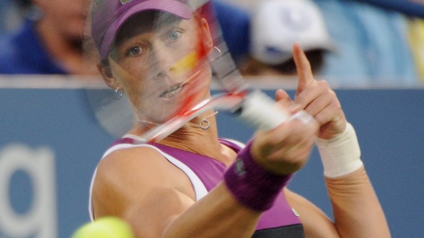 Stosur plays a forehand against Petrova